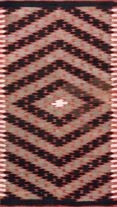 an old rug with red, black and white designs on it's edges is shown