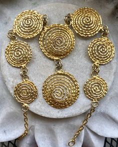 Modernist Egyptian Revival Gold Gilt Coil Spiral Vintage Bib Necklace Necklace is adjustable , measures 16 inches around the neck the front drop measures over 2 inches Beautiful, well done Adjustable Spiral Gold Necklace, Unique Gold Spiral Necklace, Adjustable Gold Spiral Necklace, Bohemian Spiral Metal Necklace, Usa Jewelry, Egyptian Revival, Bib Necklaces, Necklace Necklace, Handcrafted Necklace