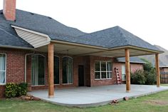 a brick house with an attached covered patio