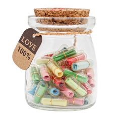 a jar filled with lots of different colored beads