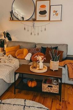 a living room filled with lots of furniture and decor on top of a hard wood floor