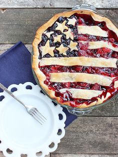 a pie with an american flag design on it and a blue napkin next to it