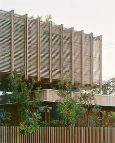 the building has wooden slats on it's sides and is surrounded by trees