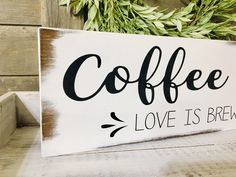 a wooden sign that says coffee love is brew