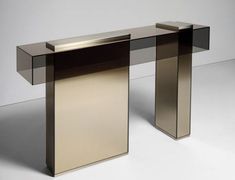 an elegant console table with glass top and metal base, designed to look like a modern desk