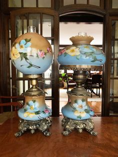 two blue vases sitting on top of a wooden table