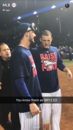 two baseball players are talking to each other