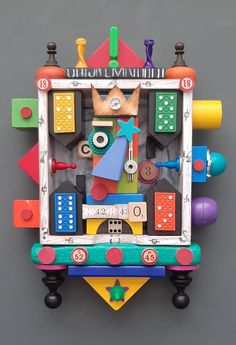 a clock made out of various colored toys