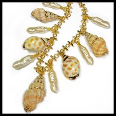 "This classy piece is made with:  ~Hand gold leaf painting ~Bali shells ~Gold novelty chain ~Long faux freshwater  pearls ~16\" length with lobster clasp and adjustment chain." Elegant Gold Shell With Lobster Clasp, Gold Pearl Shell Necklace With Pearl Drop, Handmade Gold Shell Pearl Necklace, Gold Pearl Shell Necklace Handmade, Gold Shell-shaped Pearl Necklace, Handmade Gold Shell Necklace With Pearl, Handmade Gold Shell Necklace With Pearls, Elegant Gold Shell Necklace With Lobster Clasp, Gold Mother Of Pearl Necklace For Beach