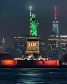 the statue of liberty lit up at night