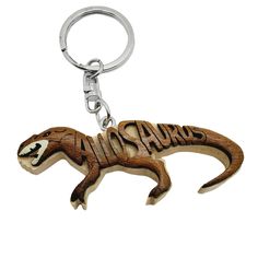 a wooden keychain with an image of a lizard on it's side