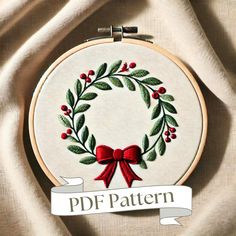 a cross stitch wreath with a red bow on it and the words pdf pattern