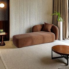 a living room filled with furniture and a large window covered in draping next to a wooden table