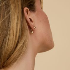 Our twist on timeless earrings combines a classic stud with an elegant dangle. For a touch of edginess, the dangle sits behind the earlobe, adding a unique twist to your look. Rest assured, these earrings are the perfect addition to any outfit or occasion. Crafted from 14k gold-filled material, they are safe for sensitive ears and provide all-day comfort. Metal: 14k Gold Filled Style: 6mm round Stud, with 8mm bead dangle Timeless Earrings, Crushed Stone, Everyday Basics, Bracelet Collection, Beaded Dangles, Sensitive Ears, Statement Earrings, Ring Earrings, Favorite Jewelry