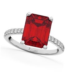 a red diamond ring with diamonds around it