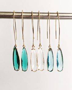 Clear, Emerald Green, and Aquamarine Teardrop and Gold Long Dangle Earrings ⟡ all items are designed and handcrafted in our studio ⟡ Long teardrop glass and gold long teardrop earrings. The glass stone is set into a gold plated over brass setting. These beautiful stones - clear diamond, emerald green, and aquamarine blue - are such beautiful stones and would be perfect to wear all year long. The long earring wire adds a dramatic but simple look that can easily be dressed up or dressed down.  This listing is for one pair of earrings.  OVERVIEW -3" in length -glass crystals -gold plated over brass (nickel free) MORE EARRINGS https://www.etsy.com/shop/Lynnique?ref=condensed_trust_header_title_reviews§ion_id=5813899 CONTINUE SHOPPING https://www.etsy.com/shop/lynnique REVIEWS "Another gorgeous Teardrop Linear Earrings For Party, Party Teardrop Linear Earrings, Teardrop French Hook Earrings As Gift, Party Teardrop Long Drop Earrings, Gift Teardrop Crystal Earrings With French Hook, Teardrop Crystal Earrings With Ear Wire As Gift, Teardrop Jewelry With Ear Wire For Parties, French Hook Dangle Earrings For Gift, Gift Teardrop Dangle Earrings With Lever Back