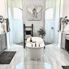 a large white bath tub sitting inside of a bathroom next to a chair and window