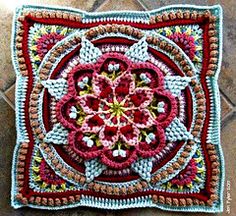 a crocheted square with a flower in the center on a tile floor,