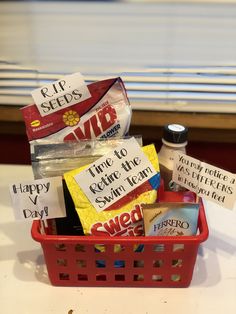 a red basket filled with candy sitting on top of a table