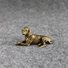 a golden dog figurine laying on the ground