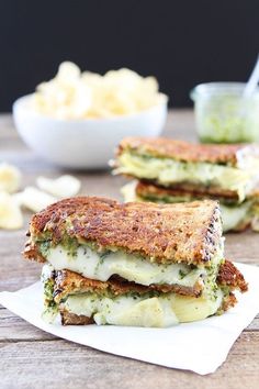 two grilled cheese sandwiches with pesto sauce