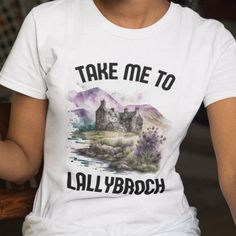 a woman wearing a white t - shirt that says take me to allybroch