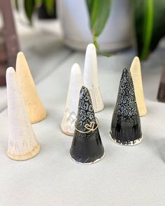 four small black and white cones sitting on top of a table