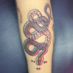 a tattoo on the leg of a person with a red and blue snake