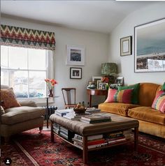 a living room with two couches and a coffee table in front of a window