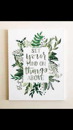 a white canvas with green leaves and the words set your mind on things above