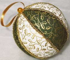 an ornament with gold and white designs on it