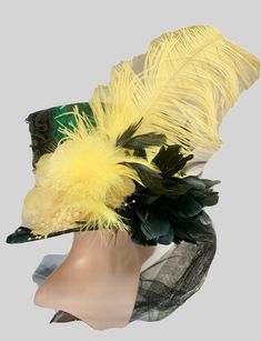 Top hat steampunk Gothic top hat Lace tophat Green top hat This is a stunning green / black lace top hat . It has front and back corseting detail with lace trim with roses and beads. To the side of the hat is a large yellow feather with a large yellow flower ,beads  and black rose. It also has a black net trail please refer to photos. This hat is a size 59cm. This hat is fully lined and well made. Any traces of glue is not a defect but characteristics of a hand created product. All my hats are o High Crown Top Hat For Carnival, Feathered Top Hat With Short Brim For Royal Ascot, Fitted Top Hat With Feathers For Royal Ascot, Short Brim Top Hat With Feathers For Royal Ascot, Fitted Feathered Costume Hats And Headpieces, Royal Ascot Top Hat With Feathers And Short Brim, Fitted Costume Hat With Feathers, Feathered Top Hat For Royal Ascot, Fitted Top Hat For Kentucky Derby Festival