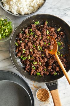 the food is being prepared in the skillet on the counter with two bowls next to it