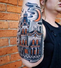 a woman with a tattoo on her arm shows an image of a castle in the sky