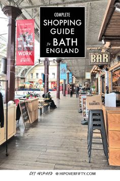 a shopping guide for bath england is hanging from the ceiling in an indoor market area