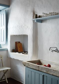 a kitchen sink sitting under a window next to a counter