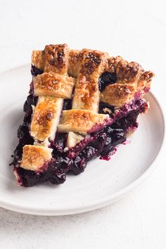 a slice of blueberry pie on a white plate