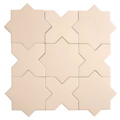 a white tile wall with several different shapes