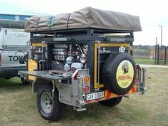 an off road vehicle parked in the grass