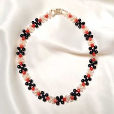 This elegant Coral, Pearl and Jade Necklace is the perfect accessory for any occasion. Delicately crafted with black jade, red coral, and freshwater pearls, this unique piece of jewelry is an eye-catching touch of sophistication to your look today! Black Jade (5mm) Red Coral (5mm) Freshwater Pearls (4mm) Goldfilled clasp Length: 15" Elegant Red Beaded Necklace With Black Beads, Elegant Red And Black Beaded Necklaces, Elegant Red And Black Beaded Necklace, Elegant Pearl Necklace With Colorful Beads For Gift, Elegant Red Beaded Pearl Necklace, Elegant Red Round Pearl Necklace, Elegant Red Pearl Necklace With Gemstone Beads, Black Jade, Jade Necklace