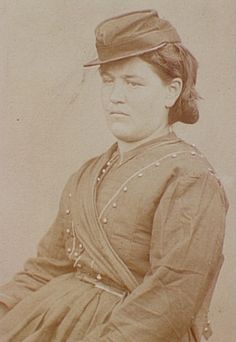 an old photo of a woman wearing a hat