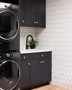 a black and white laundry room with washer and dryer