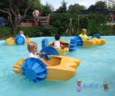 children are riding in an amusement park ride on their own rafts and paddle boats