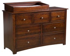 a wooden dresser with drawers and a changing table in the top drawer, against a white background