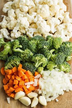 broccoli, cauliflower, onions and carrots on a cutting board