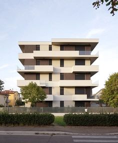 an apartment building with many balconies on the side