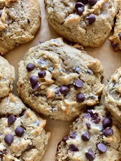 chocolate chip cookies are arranged on a piece of parchment paper