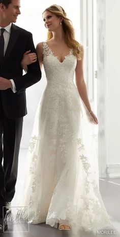 a man in a tuxedo standing next to a woman in a wedding dress