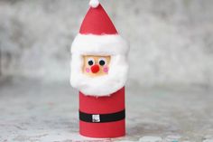 a paper roll with a santa clause on it and a red nose sticking out of it