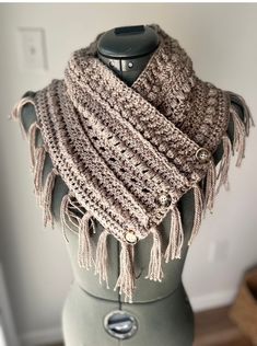 a crocheted scarf on top of a mannequin